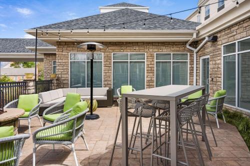 a patio with a table and chairs at Hilton Garden Inn Fort Collins in Fort Collins
