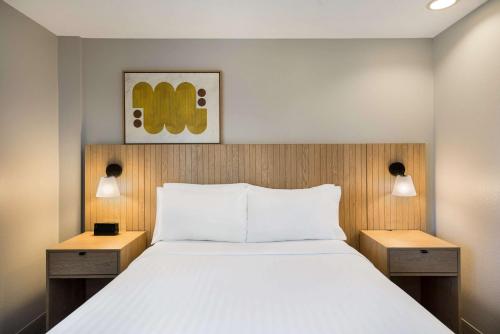 a bedroom with a large bed with two night stands at Sonesta Simply Suites Jersey City in Jersey City