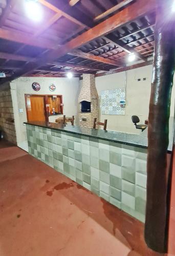 a bar in a building with a fireplace at POUSADA POR DO SOL in Olímpia