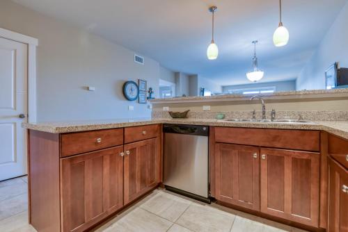 a kitchen with a sink and a dishwasher at River's Edge at Bridgeport in Seaside