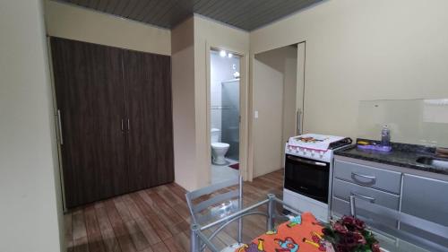 a kitchen with a sink and a stove at Casa completa com 2 quartos de casal em Torres in Torres