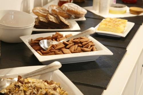 a buffet with plates of food on a table at SEVEN Hostal in Cala Millor