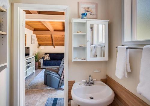 a bathroom with a sink and a chair in a room at Silver Star in Rockaway Beach