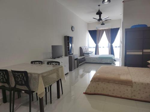 a living room with a table and chairs and a couch at STUDIO SUITE HOMESTAY KLIA in Sepang