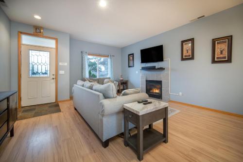 a living room with a couch and a fireplace at Necanicum House in Seaside