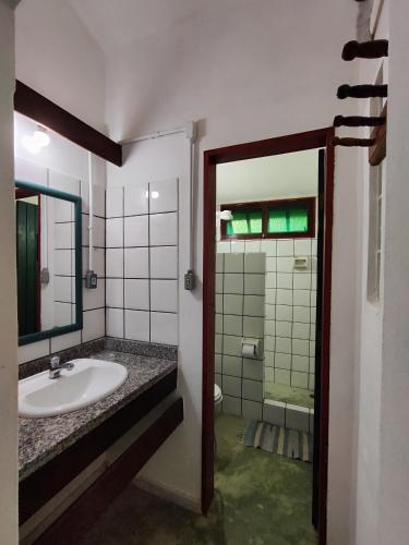 a bathroom with a sink and a mirror at Pousada São Francisco in Cumuruxatiba