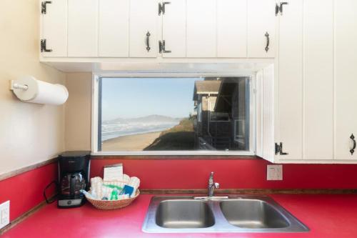a kitchen counter with a sink and a window at On The Beach in Newport