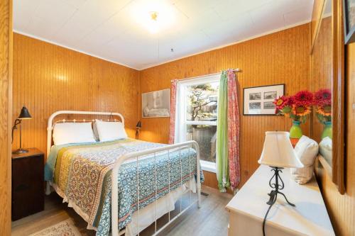 a bedroom with a bed and a window at On The Beach in Newport