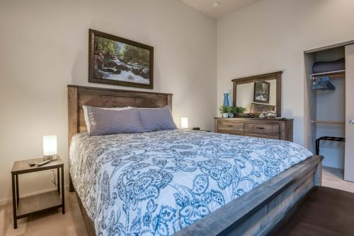 a bedroom with a blue and white bed and a mirror at Sea Depoe Bay in Depoe Bay