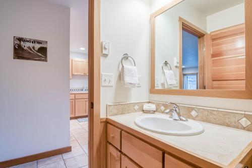 a bathroom with a sink and a mirror at Beach Break in Pacific City
