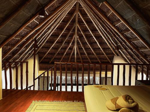a room with a large roof with a bed in it at Casa Teka in Tulum