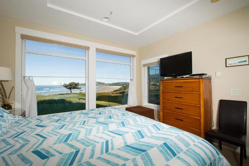 a bedroom with a bed and a television and a window at Lighthouse View at Shoreline Ridge in Newport