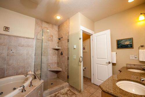 a bathroom with a tub and a shower and a sink at Lighthouse View at Shoreline Ridge in Newport