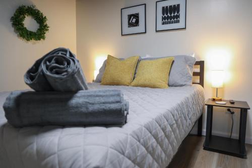 a bedroom with a bed with towels on it at 5-BR Serene Retreat Near CLE* Dogs welcome! in Berea