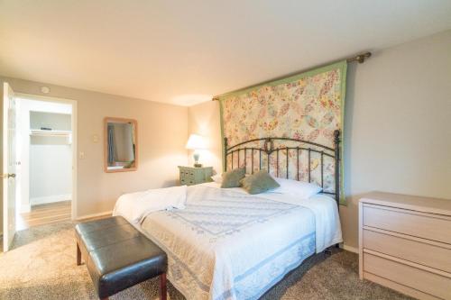 a bedroom with a bed and a tapestry on the wall at SeaQuell in Depoe Bay
