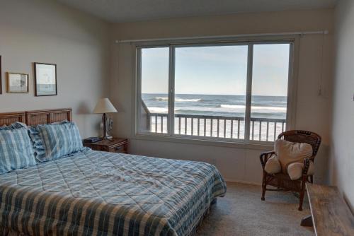 a bedroom with a bed and a view of the ocean at Pacific Sands Resort # 21 in Neskowin