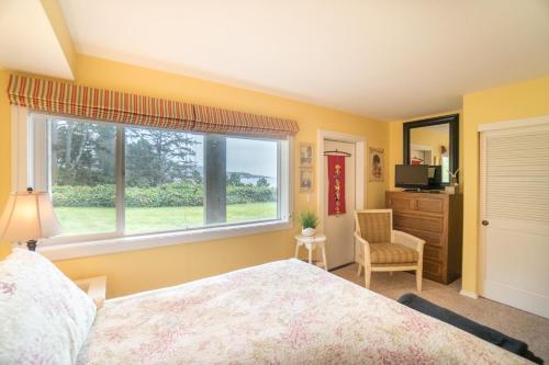 a bedroom with a bed and a window at Salt Therapy in Depoe Bay