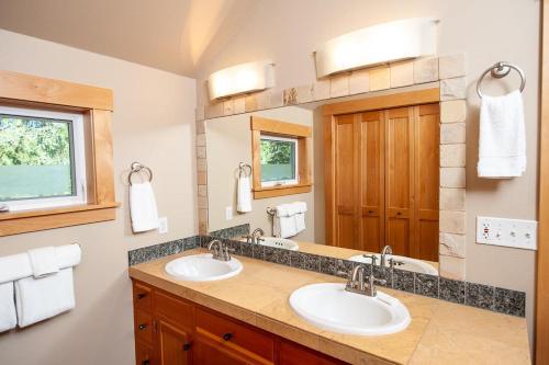 林肯市Schooner Creek Retreat的一间带两个盥洗盆和大镜子的浴室