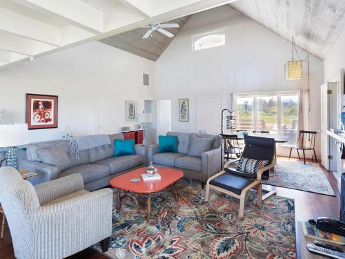 a living room with a couch and a table at Seaside Cove Vue in Seaside