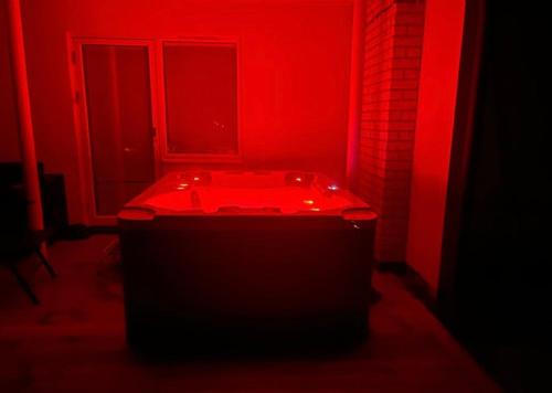 a red bathroom with a tub with a window at Swden Sunne in Sunne