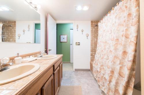 a bathroom with two sinks and a shower at Admiral 3 in Depoe Bay