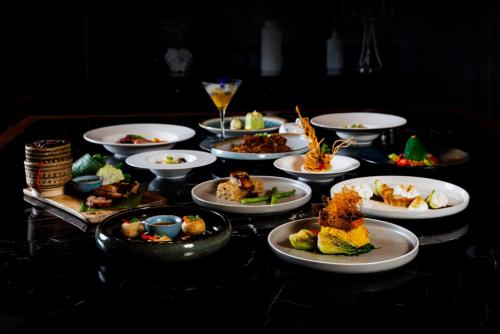 a group of plates of food on a table at Crowne Plaza Vientiane by IHG in Vientiane