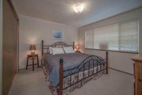 a bedroom with a large bed and a window at Oceanside Vista in Oceanside