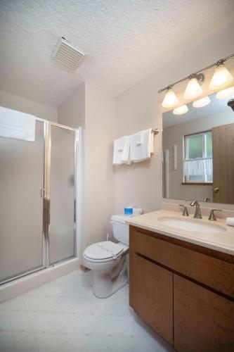 a bathroom with a toilet and a sink and a shower at Oceanside Vista in Oceanside