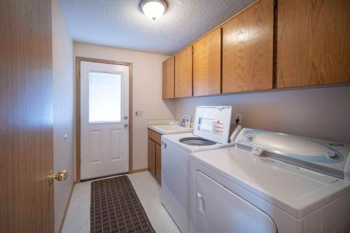 a small kitchen with a washing machine and a window at Oceanside Vista in Oceanside