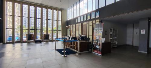 an office with a desk in a large room with windows at TIMURBAY KUANTAN -BEACHFRONT PARADISE GETAWAY in Kuantan