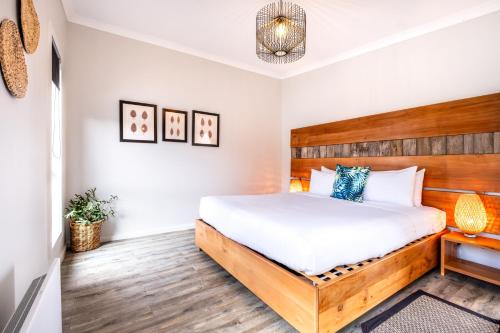 a bedroom with a bed with a wooden headboard at Whale Watcher 2 in Coles Bay