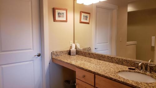 a bathroom with a sink and a mirror at Riverview Retreat in Seaside