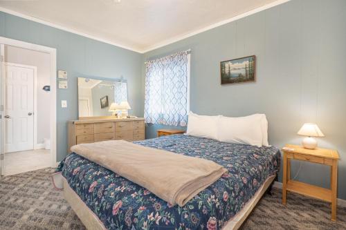 a bedroom with a bed and a dresser and a mirror at Easy Street in Rockaway Beach