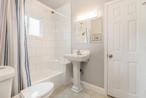 a white bathroom with a sink and a toilet at Easy Street in Rockaway Beach