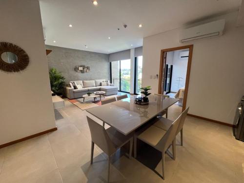 a dining room and living room with a table and chairs at Gomez de castro apartments in Asuncion