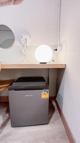 a desk with a trash can under a desk at La Moon House in Salaya