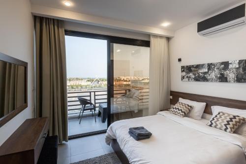 a bedroom with a bed and a balcony at Sola inn in Hurghada