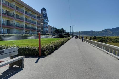 a walkway next to a building with a clock tower at Seaside Beach Club 204 in Seaside