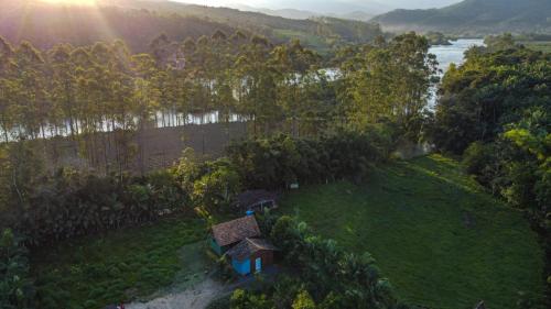 an aerial view of a house on a green field at Chalé Alpino in Apiúna
