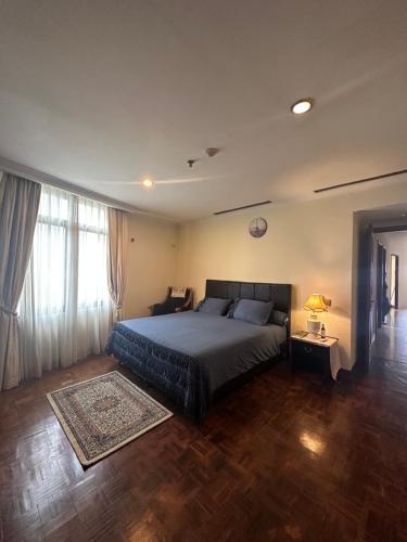 a bedroom with a bed and a large window at Apartemen Kusuma Chandra in Jakarta