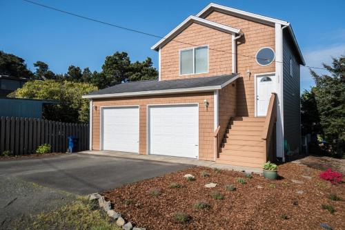 a house with two garage doors in a driveway at Family Tides in Lincoln City