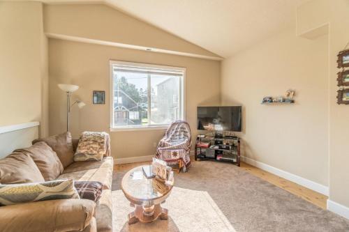 a living room with a couch and a tv at Family Tides in Lincoln City