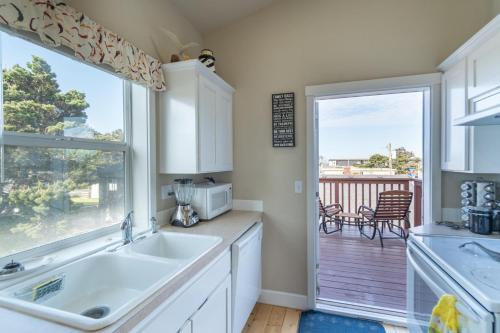 a kitchen with a sink and a large window at Family Tides in Lincoln City