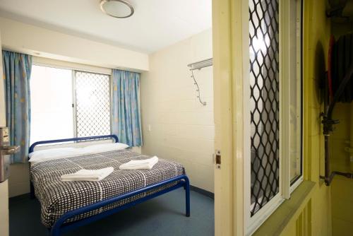 a hospital room with a bed and a window at YHA Cairns Central in Cairns