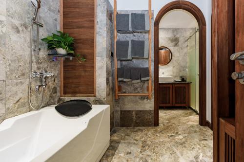 a bathroom with a white tub and a shower at Villa FLC Hạ Long bt3-6 in Ha Long