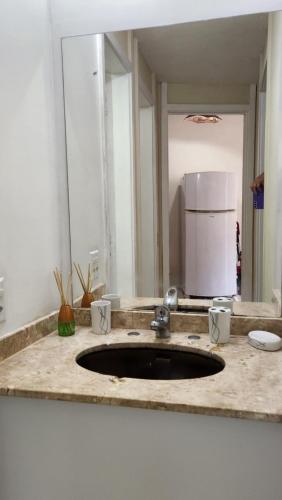 a kitchen counter with a sink and a refrigerator at Angra inn - Angra dos Reis - apê120 in Angra dos Reis