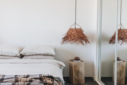 a bedroom with a bed and a mirror at Cavella North Beach in Wollongong