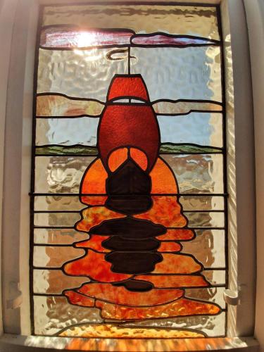a stained glass window of a bird on a pile of pancakes at Tauranga - Big, beautiful Villa on the water! in Tauranga
