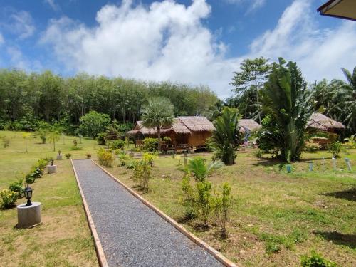 a road leading to a resort with trees at Palm Garden Bungalow in Ko Lanta