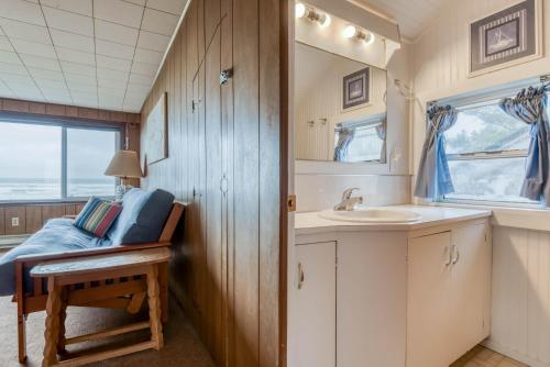 a small bathroom with a sink and a mirror at The Hamptons in Rockaway Beach
